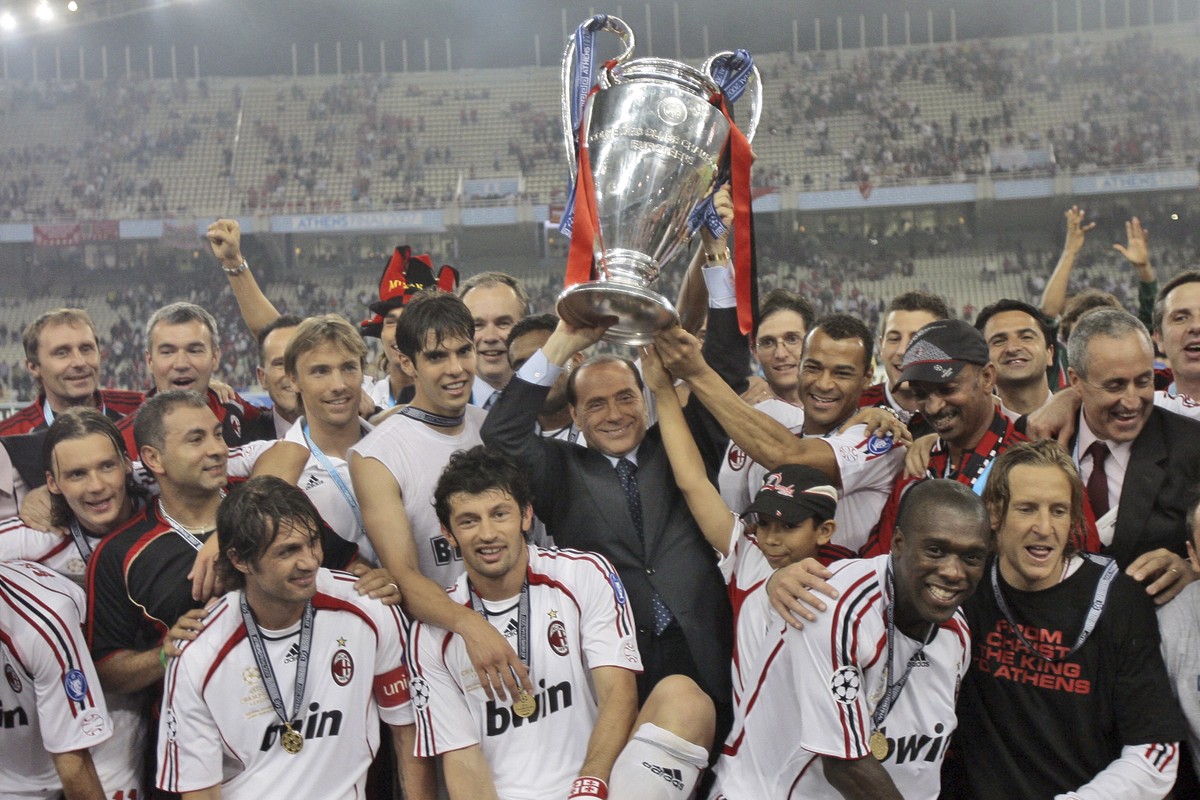 FILE - AC Milan's Silvio Berlusconi raises the trophy aloft as he stands with his team after they beat Liverpool 2-1 to win the Champions League Final soccer match between AC Milan and Liverpool  ...