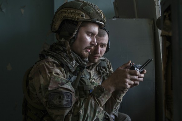 Ukrainian soldiers look at a drone screen showing Russian troops positions during heavy fighting at the front line in Severodonetsk, Luhansk region, Ukraine, Wednesday, June 8, 2022. (AP Photo/Oleksan ...