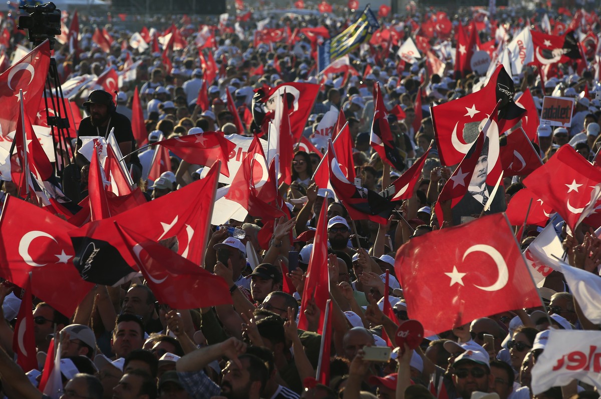 Supporters of Kemal Kilicdaroglu, the leader of Turkey's main opposition Republican People's Party, hold Turkish flags as they gather for a rally following their 425-kilometer (265-mile)   ...