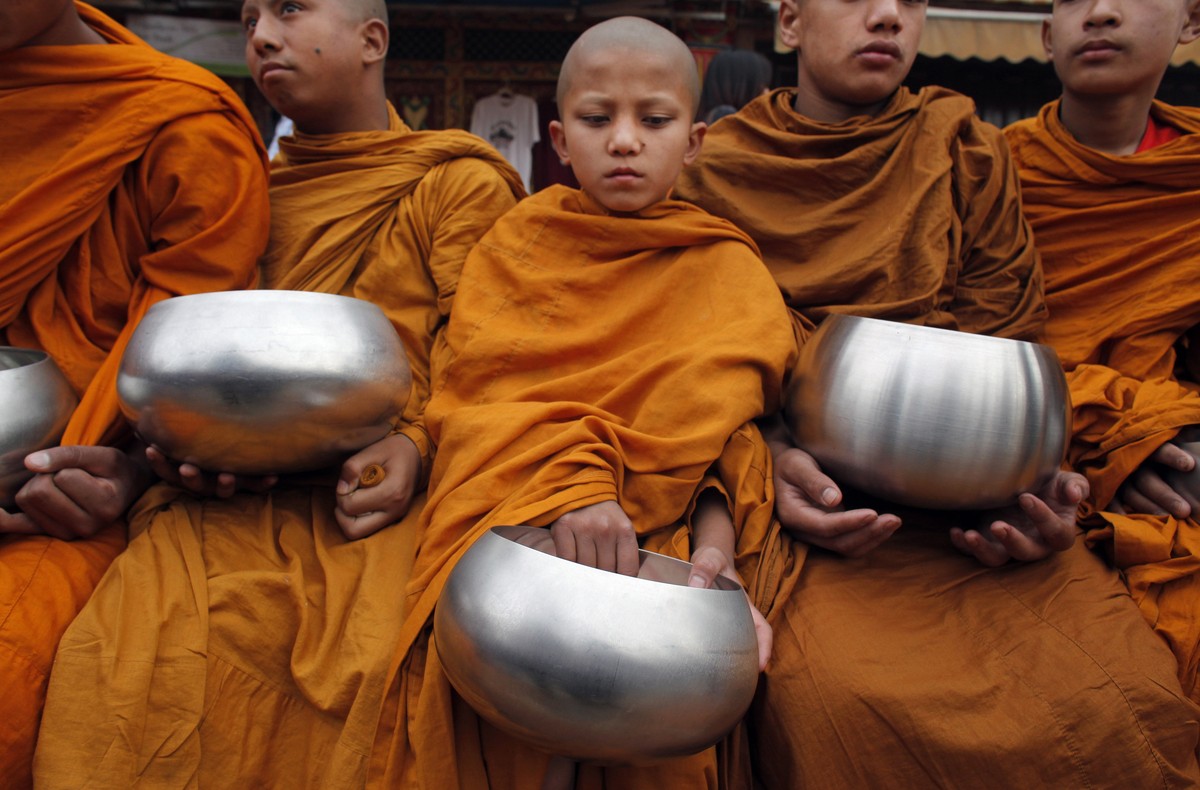 Novice Buddhist monks wait for alms during Buddha Jayanti, or Buddha Purnima festival in Kathmandu, Nepal, Saturday, May 21, 2016. The festival marks the triple events of Gautam Buddha's life: hi ...