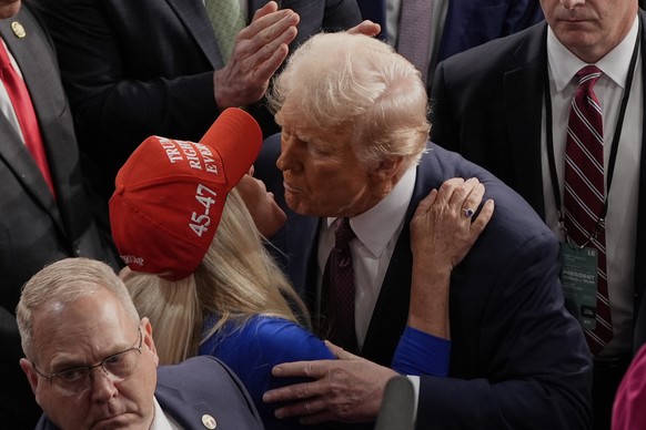 President Donald Trump greets Rep. Marjorie Taylor Greene, R-Ga., after addressing a joint session of Congress in the House chamber at the U.S. Capitol in Washington, Tuesday, March 4, 2025. (AP Photo ...
