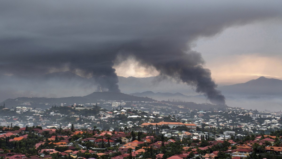 FILE - Smoke rises during protests in Noumea, New Caledonia, Wednesday May 15, 2024. (AP Photo/Nicolas Job, File)