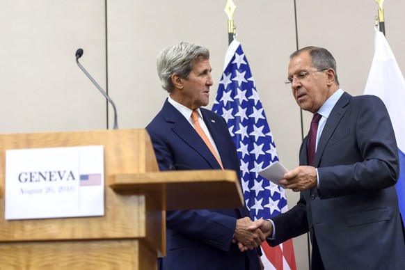 U.S. Secretary of State John Kerry, left, and Russian Foreign Minister Sergey Lavrov, right, shake hands after their meeting in Geneva, Switzerland, Friday, Aug. 26, 2016. The United States and Russia ...