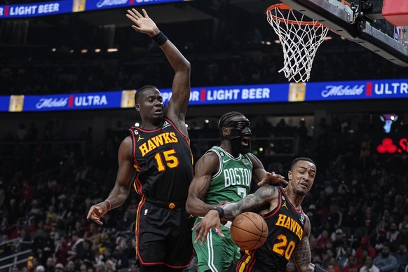 Atlanta Hawks&#039; Clint Capela (15) and John Collins (20) fight for the rebound against Boston Celtics&#039; Jaylen Brown (7) during the first half of Game 6 of a first-round NBA basketball playoff  ...