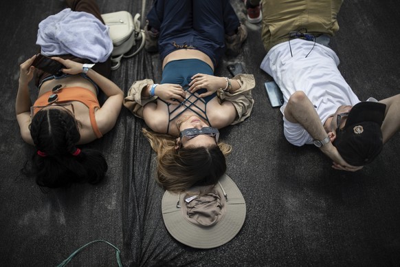 People look at A "ring of fire" solar eclipse in the Tatacoa Desert, Colombia, Saturday, October 8.  August 14, 2023. The annular solar eclipse darkened the sky over parts of the western U.S. and Central and South America...