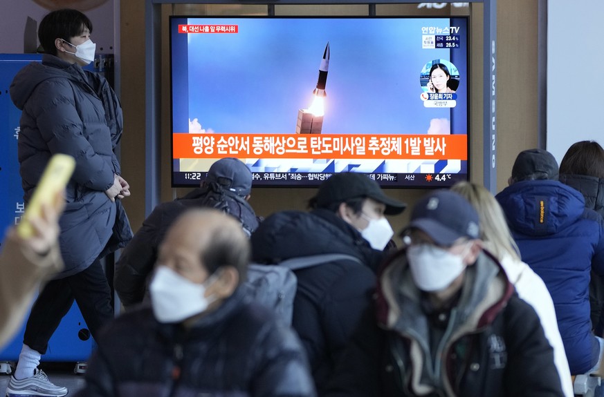 People watch a TV showing a file image of North Korea&#039;s missile launch during a news program at the Seoul Railway Station in Seoul, South Korea, Saturday, March 5, 2022. North Korea on Saturday f ...