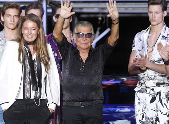 Italian fashion designer Roberto Cavalli, center, acknowledges the applause of the audience after presenting the Roberto Cavalli men&#039;s Spring-Summer 2015 collection, part of the Milan Fashion Wee ...