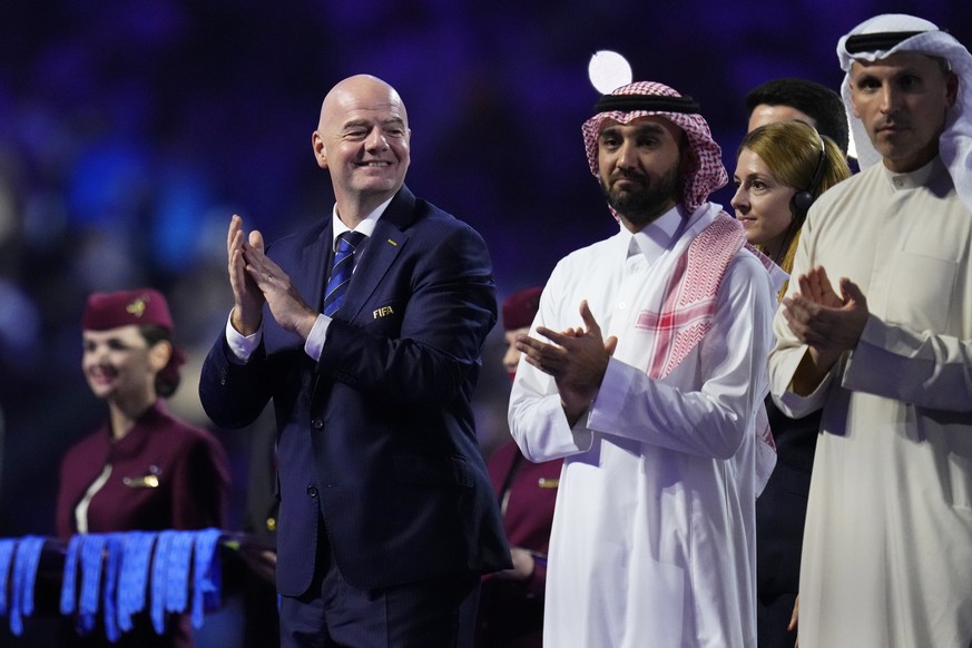 FIFA President Gianni Infantino, left, applauds during the medals ceremony after the Soccer Club World Cup final match between Manchester City FC and Fluminense FC at King Abdullah Sports City Stadium ...
