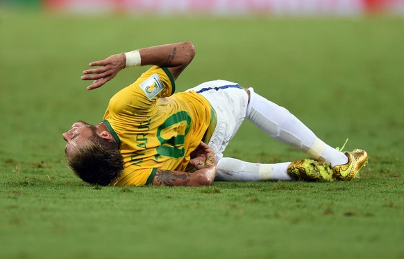 JAHRESRUECKBLICK 2014 - FUSSBALL WM 2014 - Neymar of Brazil lies on the pitch after picking up an injury during the FIFA World Cup 2014 quarter final match soccer between Brazil and Colombia at the Es ...