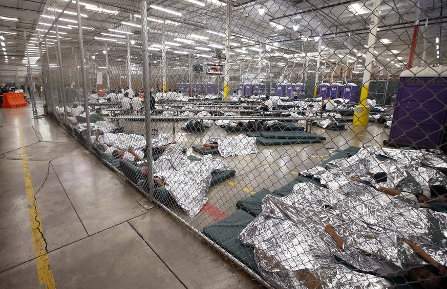 Detainees sleep and watch television in a holding cell where hundreds of mostly Central American immigrant children are being processed and held at the U.S. Customs and Border Protection (CBP) Nogales ...
