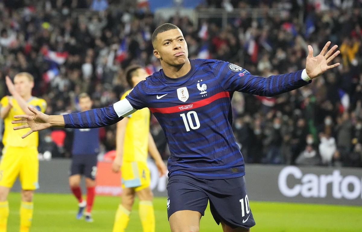France's Kilian Mbappe celebrates after scoring his side's third goal during the World Cup 2022 group D qualifying soccer match between France and Kazakhstan at the Parc des Princes stadium  ...