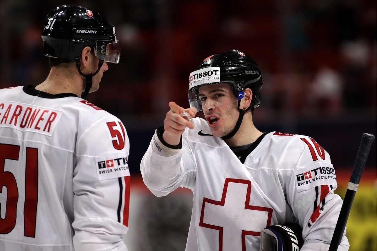 Switzerland's Raphael Diaz, right, speaks with his teammate Ryan Gardner, left, during the IIHF Ice Hockey World Championships preliminary round game Belarus vs Switzerland at the Globe Arena in  ...