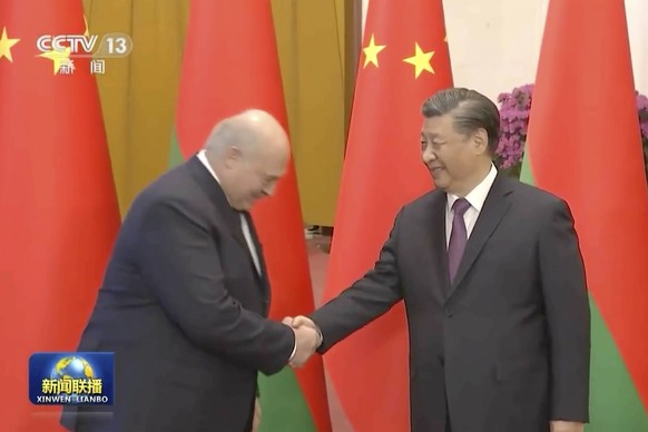 In this image taken from video footage run by China&#039;s CCTV, Belarusian President Alexander Lukashenko, left, shakes hands with Chinese President Xi Jinping during a welcome ceremony held at the G ...