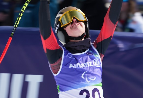 Andrea Rothfuss, of Germany, reacts after crossing the finish line in the alpine skiing women's super-G standing final at the 2026 Winter Paralympics, in Cortina d'Ampezzo, Italy, Monday, Ma ...