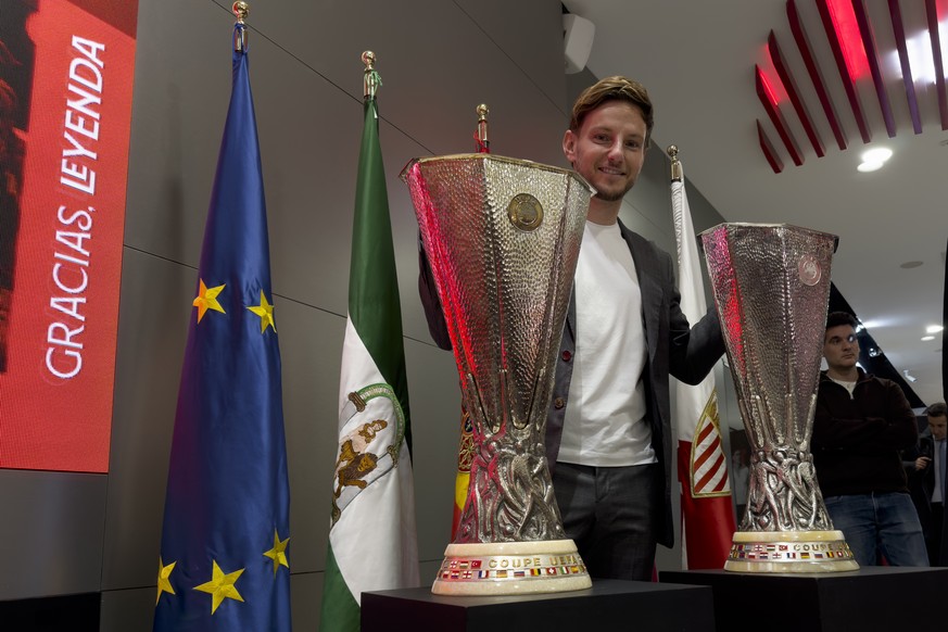 epa11114201 Croatian midfielder Ivan Rakitic poses next to Europa League trophies during his farewell press conference in Seville, Spain, 30 January 2024. Rakitic leaves Sevilla FC after 323 official  ...