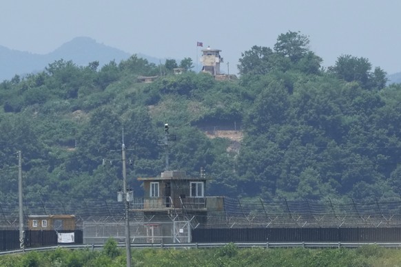 A North Korean military guard post, top, and a South Korean post, bottom, are seen from Paju, South Korea, near the border with North Korea, Tuesday, June 18, 2024. South Korean soldiers fired warning ...