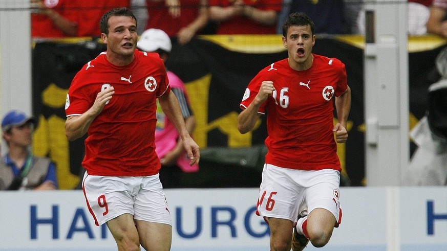 Alexander Frei, left, and Tranquillo Barnetta, right, who scored the 2nd goal for his team, celebrate after Frei scored the 1:0 during the Group G match between Switzerland and Togo in Dortmund&#039;s ...