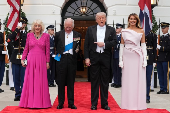 President Donald Trump and first lady Melania Trump greet Britain's King Charles III and Queen Camilla at the South Portico of the White House as they arrive for a State Dinner Tuesday, April 28, ...