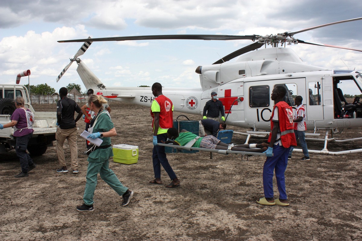 FILE - Medical staff with the International Committee of the Red Cross (ICRC) and South Sudan Red Cross, move a wounded patient to an ambulance in Akobo, South Sudan, May 24, 2025. (AP Photo/Joseph Fa ...