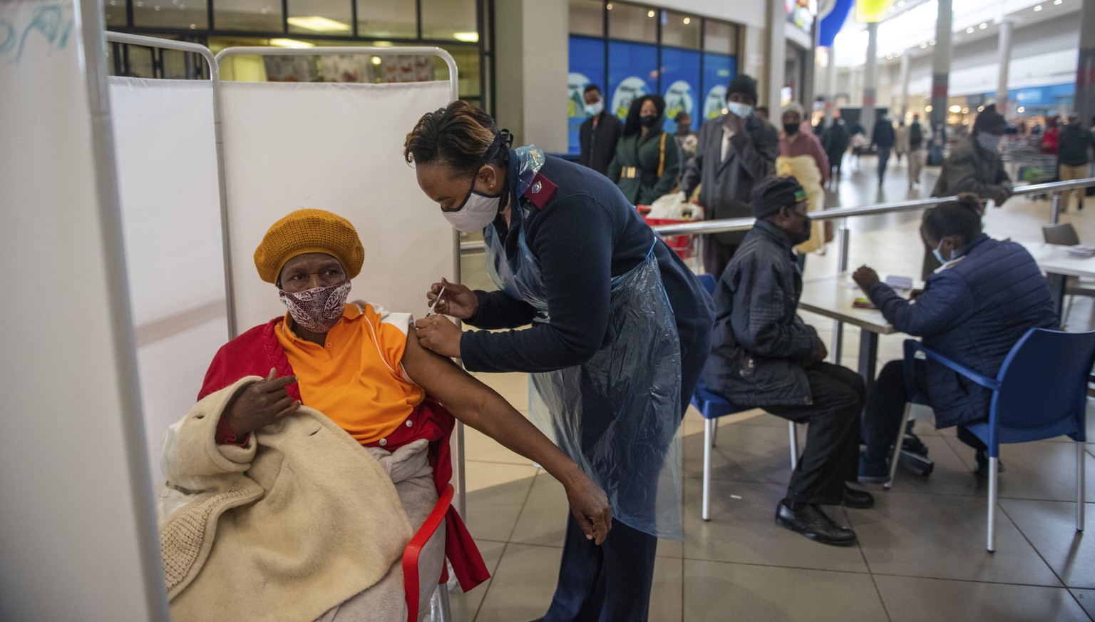 FILE - In this July 6, 2021, file photo, a patient receives a Johnson &amp; Johnson vaccine against COVID-19 in Hammanskraal, South Africa. New infections in South Africa rose to record levels in rece ...