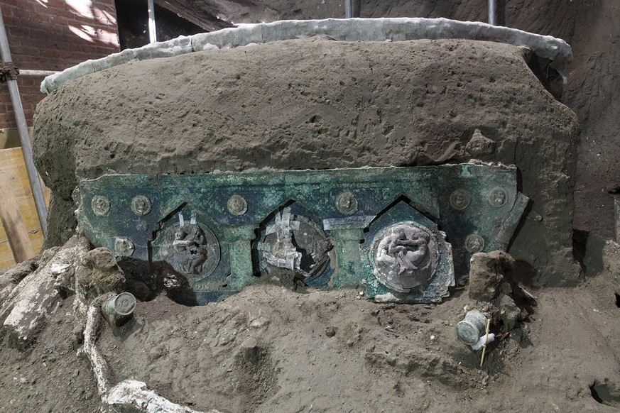 A view of a chariot, with its iron elements, bronze decorations and mineralized wooden remains, that was found in Civita Giuliana, north of Pompeii. Officials at the Pompeii archaeological site near N ...