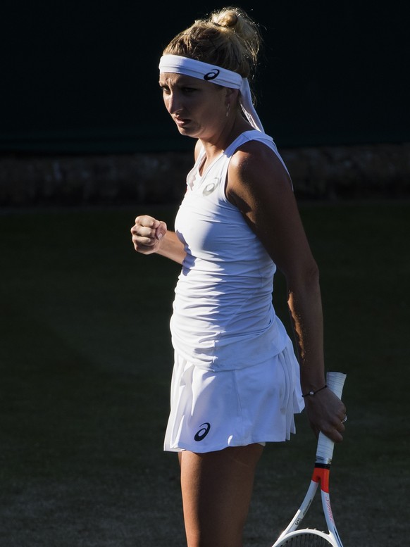 Timea Bacsinszky of Switzerland reacts after winning a point during her first round match against Monica Puig of Puerto Rico, at the Wimbledon Championships at the All England Lawn Tennis Club, in Lon ...