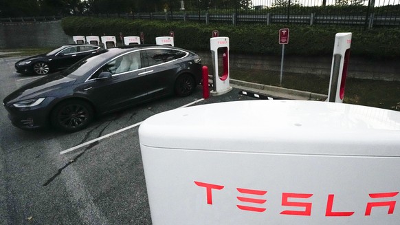 FILE - A Tesla vehicles charge, Wednesday, Sept. 27, 2023, in Woodstock, Ga. Tesla reports their earnings on Wednesday, Jan. 24, 2024. (AP Photo/Mike Stewart, File)