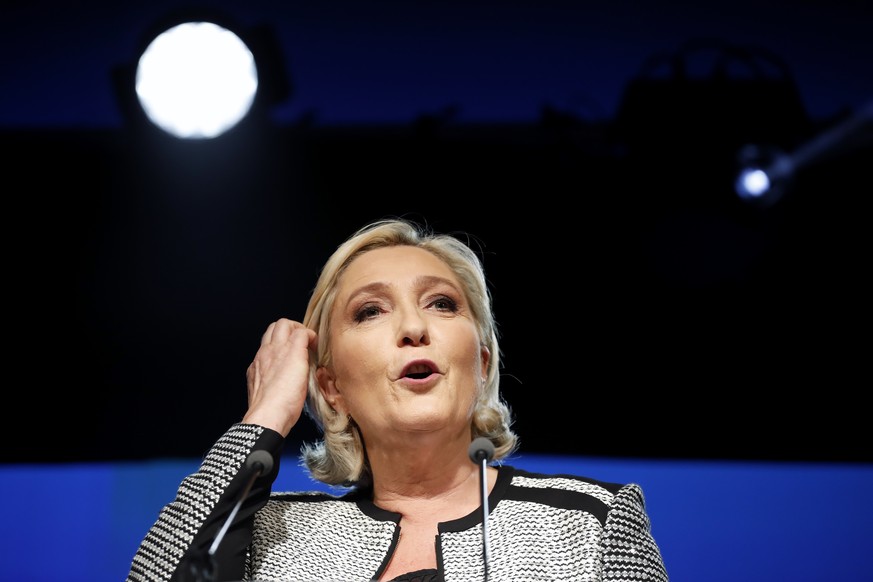 French far right leader Marine Le Pen gestures as she delivers a speech to announce a name-change for her National Front party, in Bron, central France, Friday, June 1, 2018. The new name of the party ...