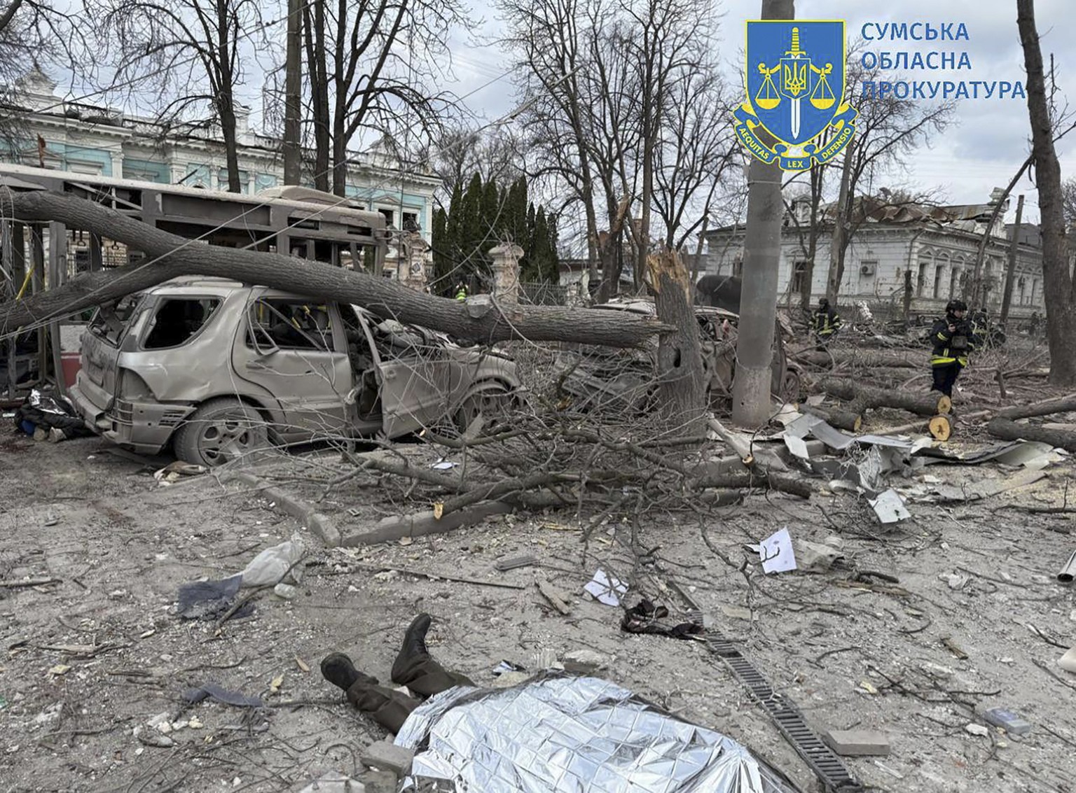 epa12028823 A handout photo made available by the Sumy Region Prosecutor&#039;s Office shows the site of a rocket strike in downtown Sumy, Ukraine, 13 April 2025, amid the ongoing Russian invasion. At ...