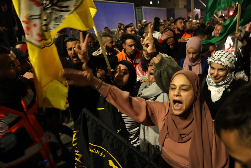 epa10993229 Recently freel Paletsinian prisoners celebrate with crowds that were awaiting for them, after leaving the Isareli Ofer military prison, in the town of Beitonia near Ramallah, West Bank, 24 ...