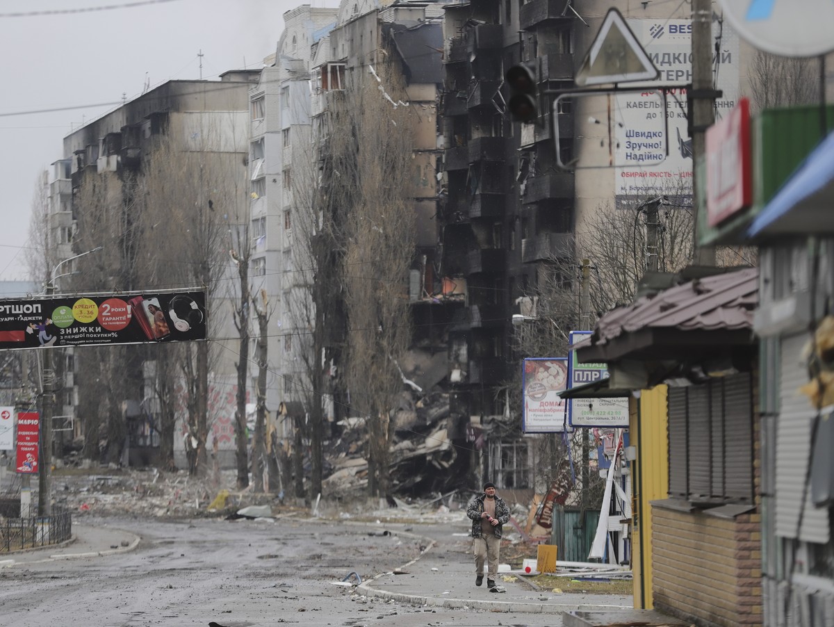 epa09799165 A man goes past burned buildings that were hit by shelling in the small city of Borodyanka near Kiev, Ukraine, 03 March 2022. Russian troops entered Ukraine on 24 February prompting the co ...