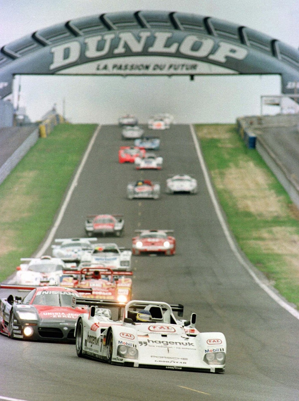 The TWR Porsche driven by Michele Alboreto of Italy, Stephan Johansson of Sweden and Tom Kristensen of Danemark is pictured in the first lap of the 24-hour endurance race in Le Mans, Saturday June 14, ...