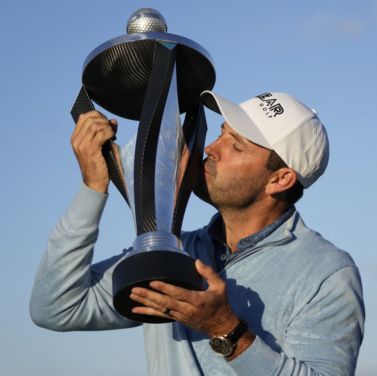 Charles Schwartzel of South Africa kisses the trophy as he poses for the media after he won the inaugural LIV Golf Invitational at the Centurion Club in St Albans, England, Saturday, June 11, 2022. (A ...