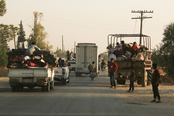 Syrians flee shelling by Turkish forces in Ras al Ayn, northeast Syria, Wednesday, Oct. 9, 2019. Turkish President Recep Tayyip Erdogan announced Wednesday the start of a Turkish military operation ag ...