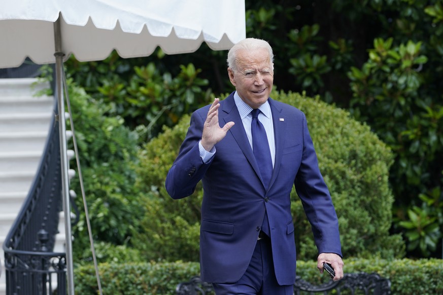 President Joe Biden tries to hear questions shouted by reporters as he heads to Marine One on the South Lawn of the White House in Washington, Friday, July 16, 2021, to spend the weekend at Camp David ...
