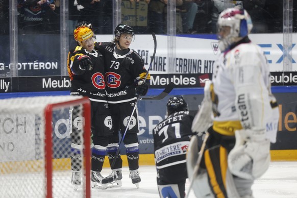 Gotteron PostFinance top scorer Marcus Sorensen, left, celebrates with teammate Sandro Schmid after scoring the goal to make it 6-3 in the National League ice hockey championship game between HC Fribourg Gotter...