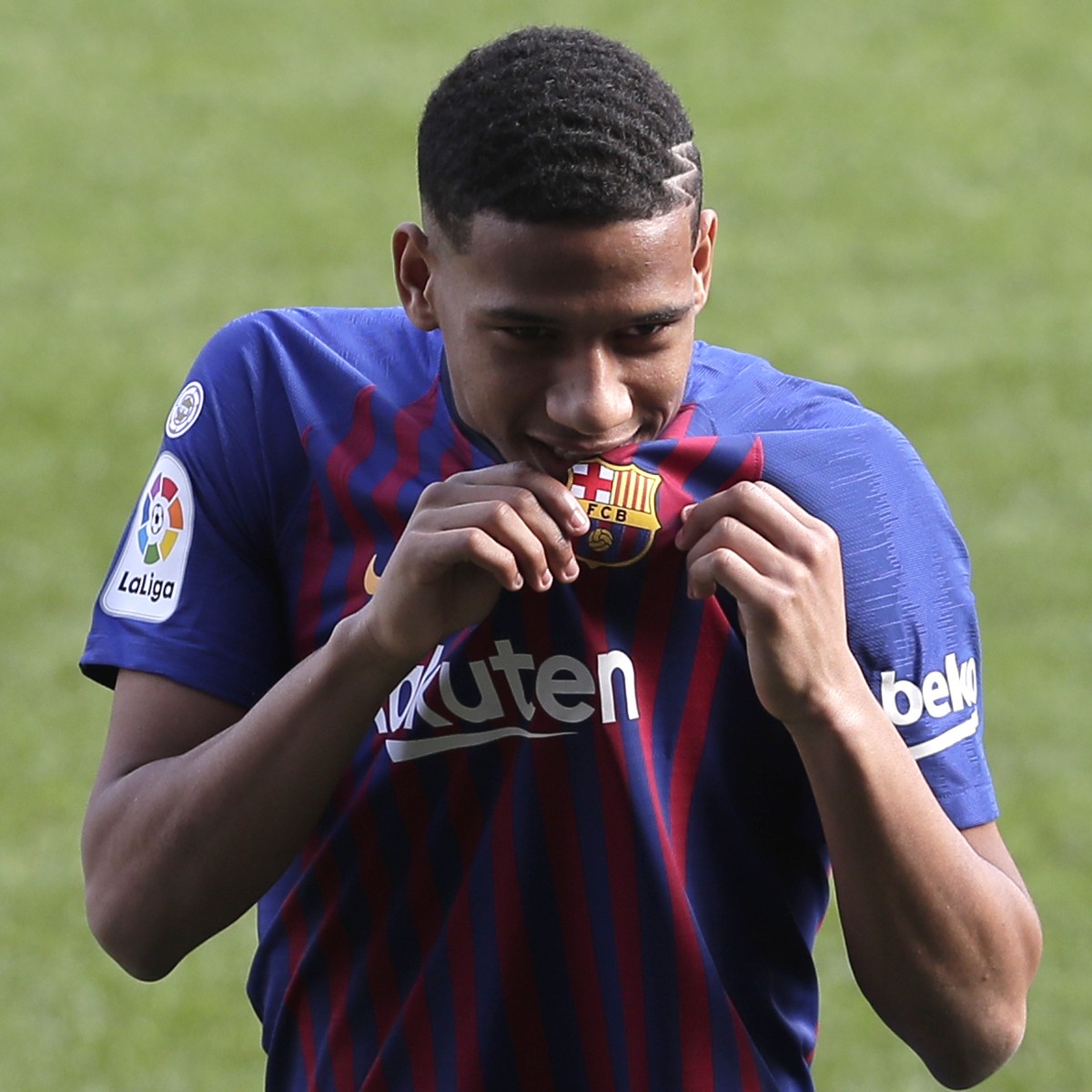 Barcelona's new signing soccer player Jean-Clair Todibo kisses his new shirt during his official presentation at the Camp Nou stadium in Barcelona, Spain, Friday, Feb. 1, 2019. Barcelona announce ...
