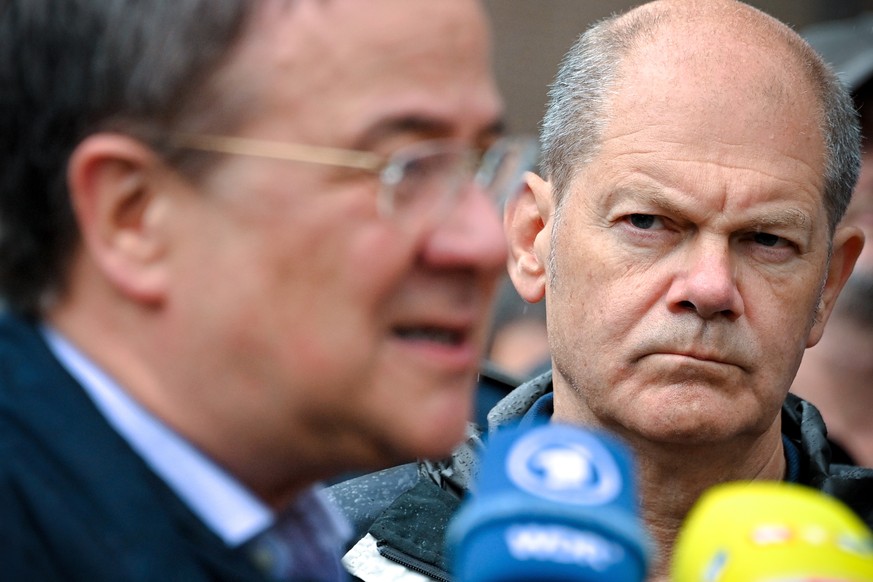 epa09391199 Top candidates for the federal elections, Prime Minister of North Rhine-Westphalia Armin Laschet (L) and German Minister of Finance Olaf Scholz (R), speak to the media following an inspect ...