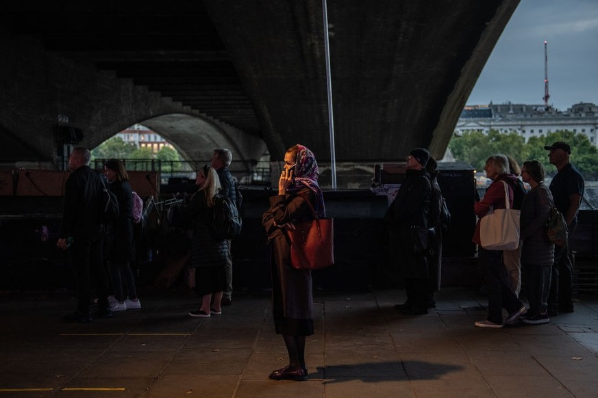 LONDON, ENGLAND - SEPTEMBER 15: Well-wishers stand in the queue along Southback for the Lying-in State of Queen Elizabeth II on September 15, 2022 in London, England. Queen Elizabeth II is lying in st ...