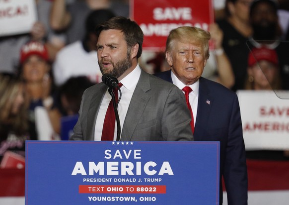 epa10190796 J.D. Vance (L), Republican Nominee for US Senator for Ohio, appears on stage at a Save America rally with former US President Donald Trump (R) at the Covelli Centre in Youngstown, Ohio, US ...