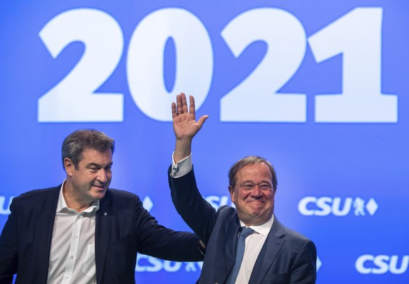 Markus SÃ¶der, left, CSU party leader and prime minister of Bavaria, and Armin Laschet, CDU/CSU candidate for chancellor, are on stage together at the CSU party conference in Nuremberg, Germany, Satur ...