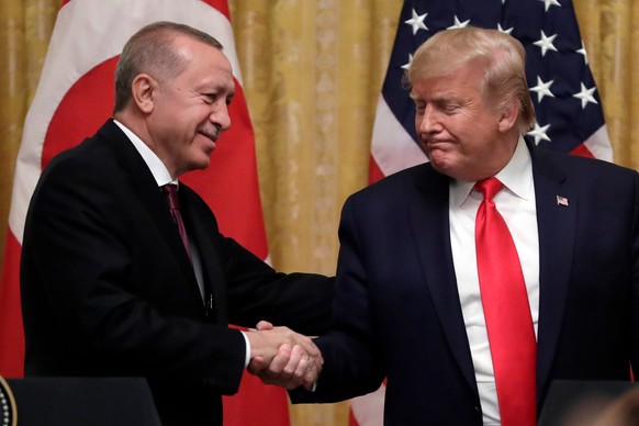 FILE - President Donald Trump shakes hands with Turkey&#039;s President Recep Tayyip Erdogan after a news conference in the East Room of the White House, Nov. 13, 2019, in Washington. (AP Photo/ Evan  ...