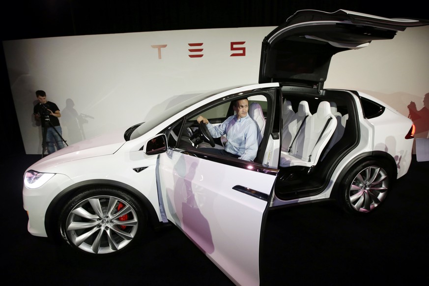 A Tesla executive displays the new Model X car at the company&#039;s headquarters Tuesday, Sept. 29, 2015, in Fremont, Calif. CEO Elon Musk says the Model X sets a new bar for automotive engineering,  ...