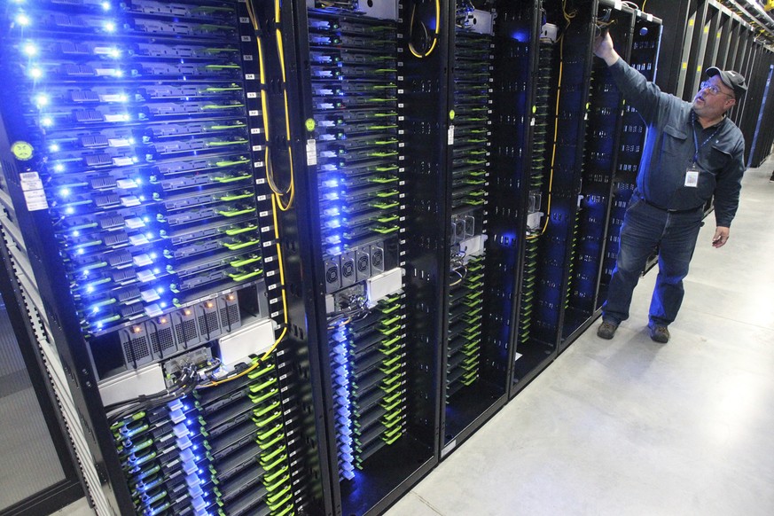 FILE - In this Oct. 15, 2013, file photo, Chuck Goolsbee, site director for Facebook&#039;s Prineville data centers, shows the computer servers that store users&#039; photos and other data, at the Fac ...