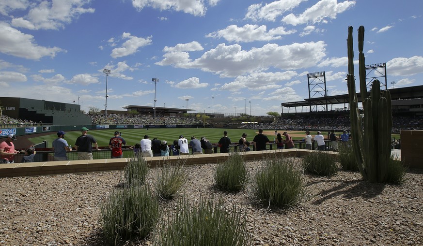 Fans at Salt River Fields at Talking Stick watch along the left field foul line during the fifth inning of a spring training baseball game between the Colorado Rockies and the Arizona Diamondbacks in  ...