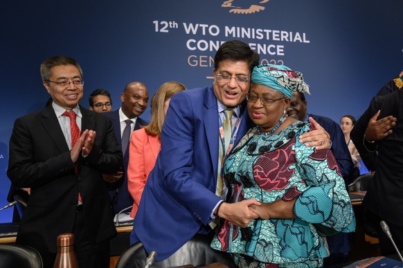 epa10017497 World Trade Organization Director-General Ngozi Okonjo-Iweala (R), is congratulated by Indian Minister of Commerce Piyush Goyal, after the closing session of the World Trade Organization M ...