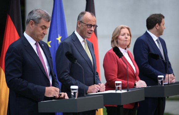 epa13079486 (L-R) Bavaria's State Premier Markus Soeder, German Chancellor Friedrich Merz, German Labour Minister Baerbel Bas and German Finance Minister Lars Klingbeil attend a news conference a ...