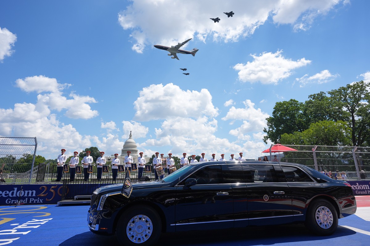Air Force One and four F-35's pass over as President Donald Trump, in the presidential limousine known as "The Beast," does a lap around the track before the IndyCar Freedom 250 Grand P ...