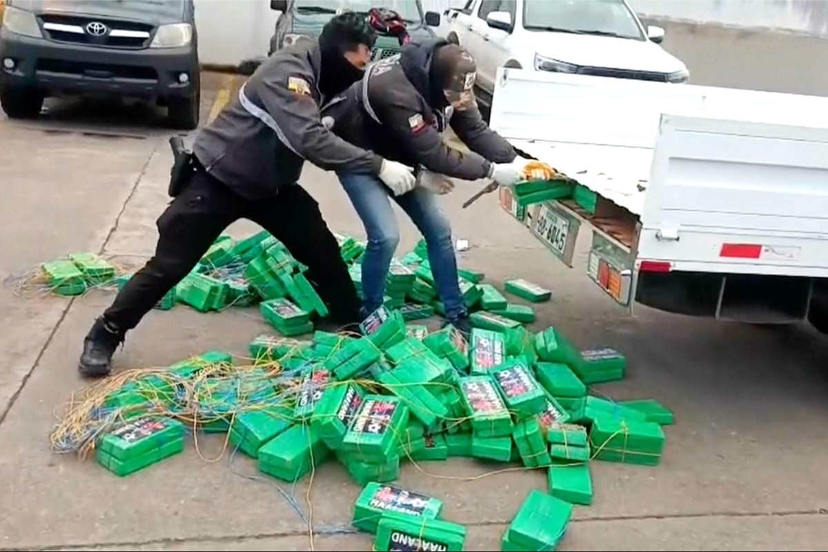 In this image from a video released by Ecuador National Police, Ecuadorian police remove alleged bricks of cocaine from a truck in Carchi, Ecuador Wednesday, Aug. 12, 2026. (Ecuador National Police vi ...