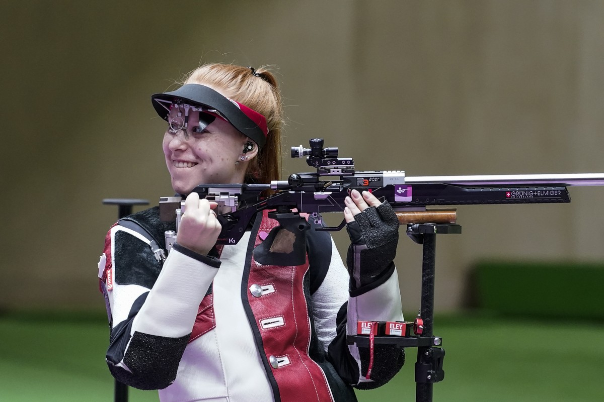 Nina Christen, of Switzerland, reacts after the last shot in the women's 50-meter 3 positions rifle at the Asaka Shooting Range in the 2020 Summer Olympics, Saturday, July 31, 2021, in Tokyo, Jap ...